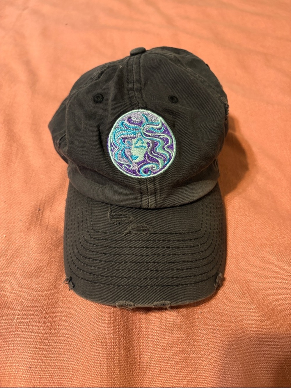 Black Distressed Baseball Cap with Purple/Teal Embroidered Madam Leota Patch